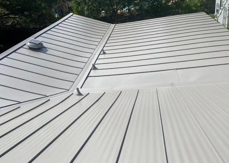 Solar attic fan installed on a metal roof for Roof Ventilation in Griffith